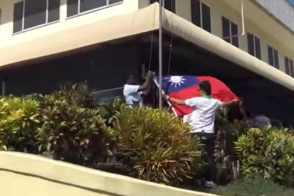 The Taiwanese flag is lowered in Honiara after the Solomon Islands switched diplomatic recognition to Beijing. Photo: Reuters