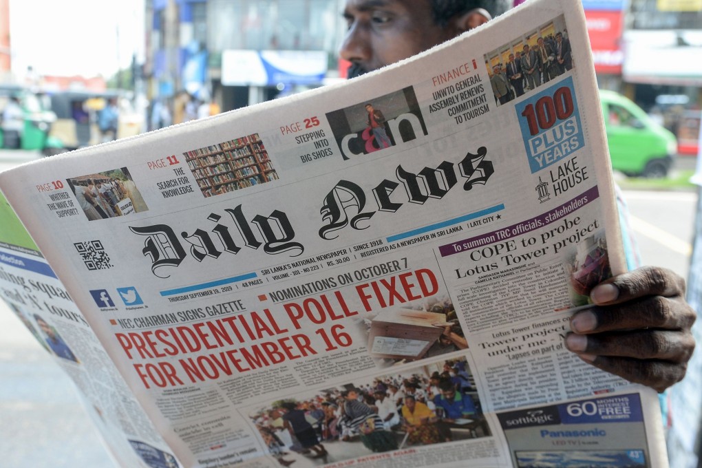 A Colombo, Sri Lanka man reads a newspaper on September 19 reporting the news that Sri Lanka’s Election Commission will hold presidential polls on November 16. Photo: AFP