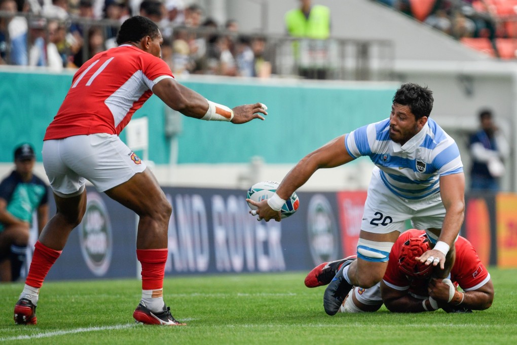 Argentina back row Javier Ortega Desio passes the ball as he is tackled during his team’s match against Tonga at the 2019 Rugby World Cup. Photo: AFP