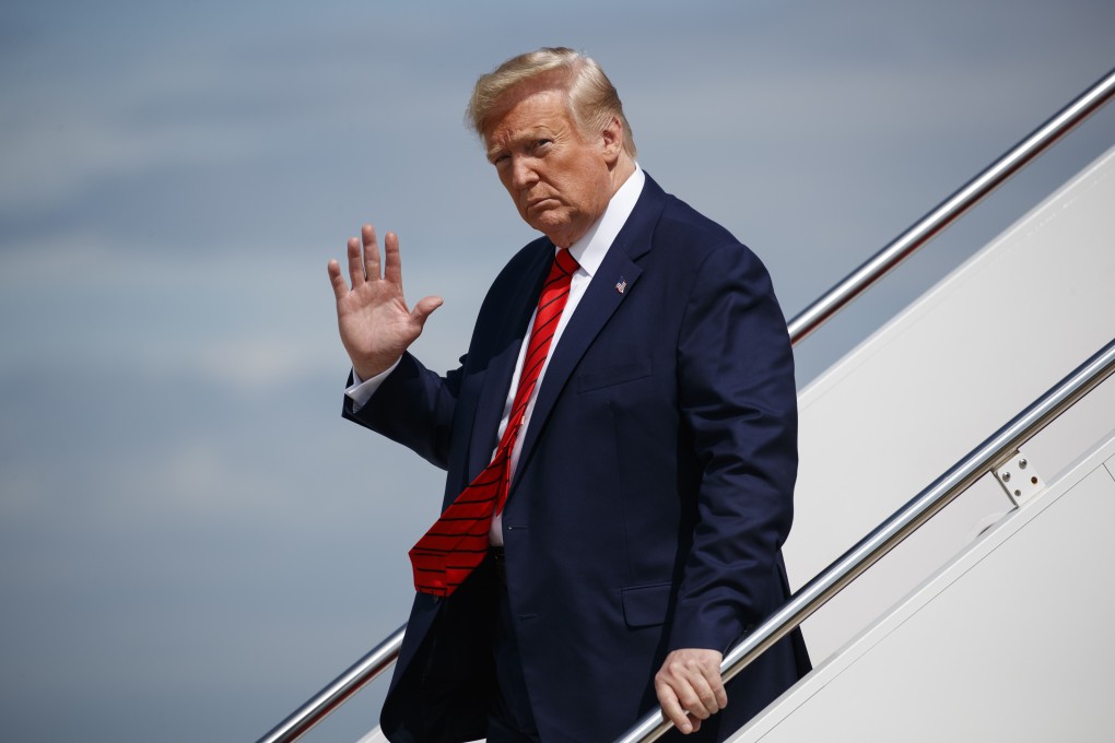 President Donald Trump waves to reporters as he steps off Air Force One. Photo: AP Photo
