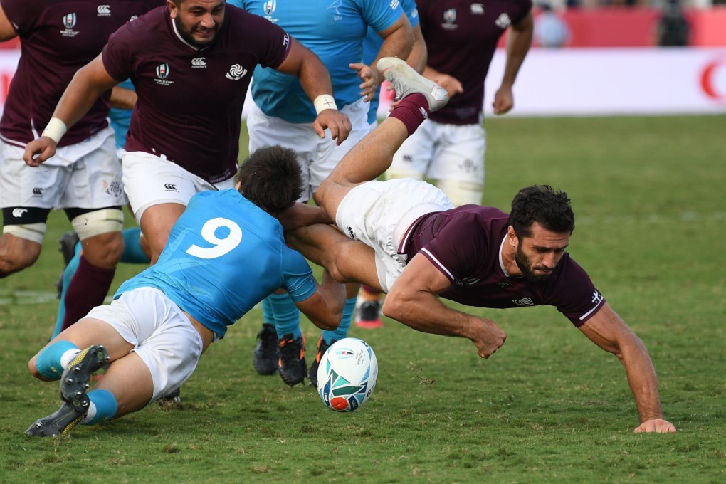 Georgia’s Zura Dzneladze (right) is tackled by Uruguay’s scrum-half Santiago Arata. Photo: AFP