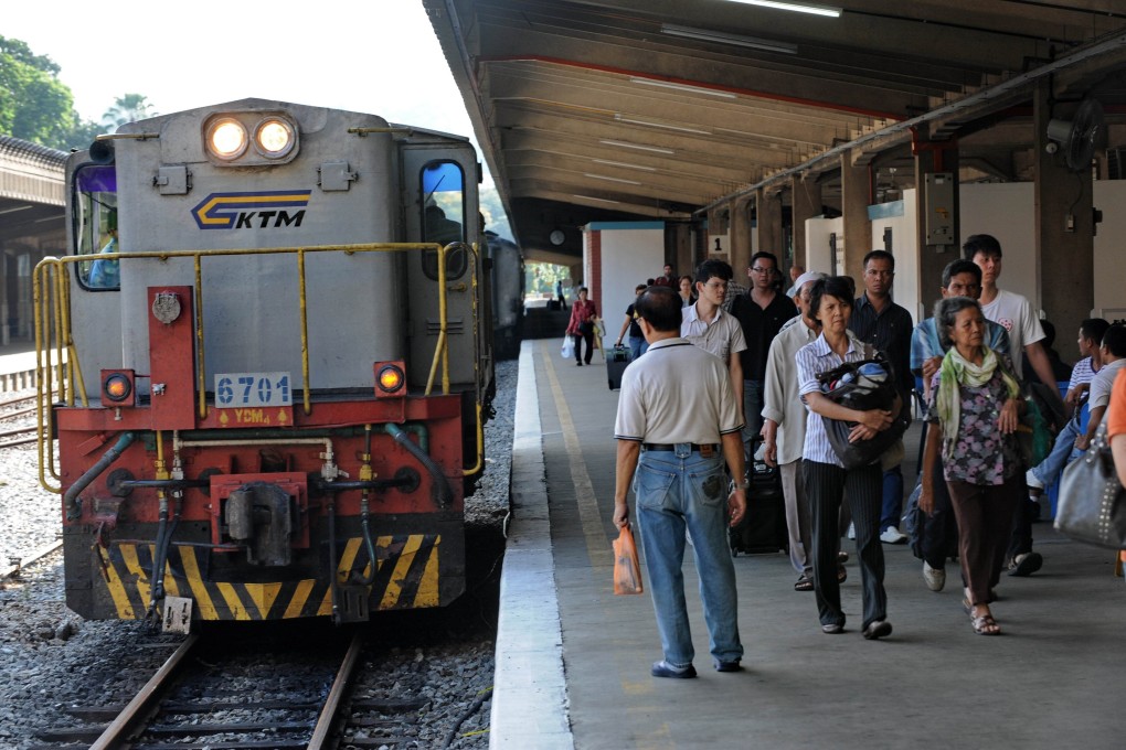 Commuters arrive at a railway station in Singapore. Photo: AFP