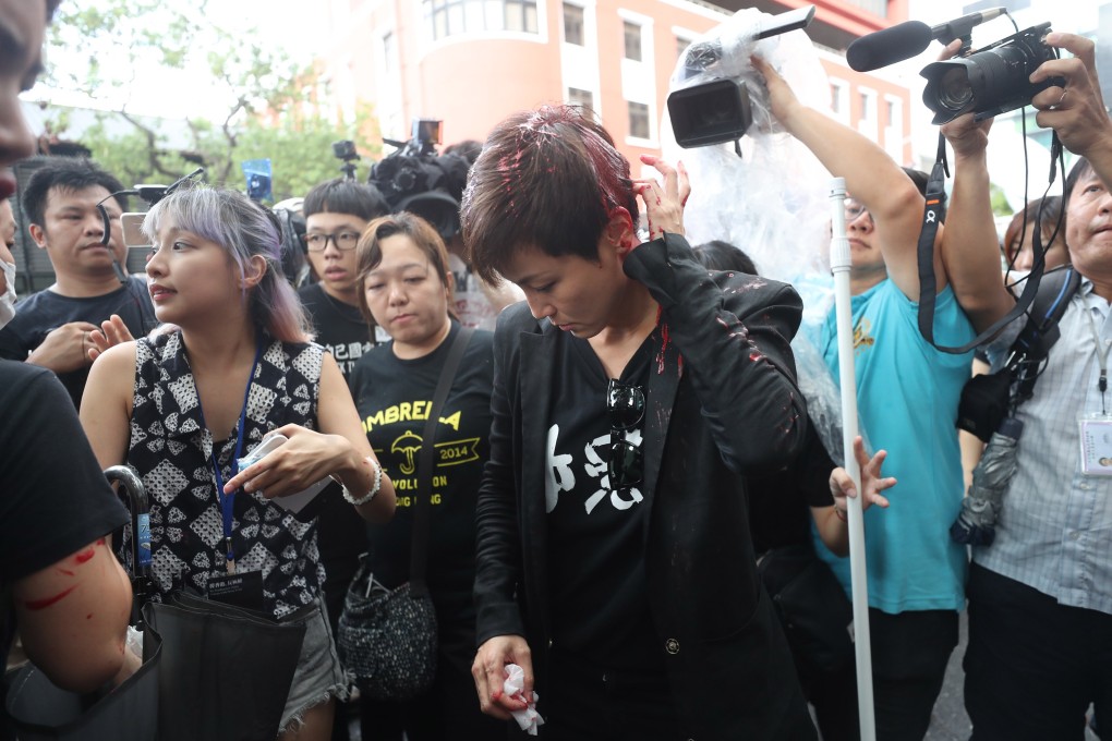 A masked man threw red paint over Denise Ho’s head as she was speaking to the media. Photo: CNS