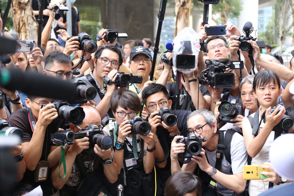 Photographers record a protest outside the British consulate in Hong Kong. Journalists have been working long hours covering the unrest in the city. Photo: Rachel Cheung