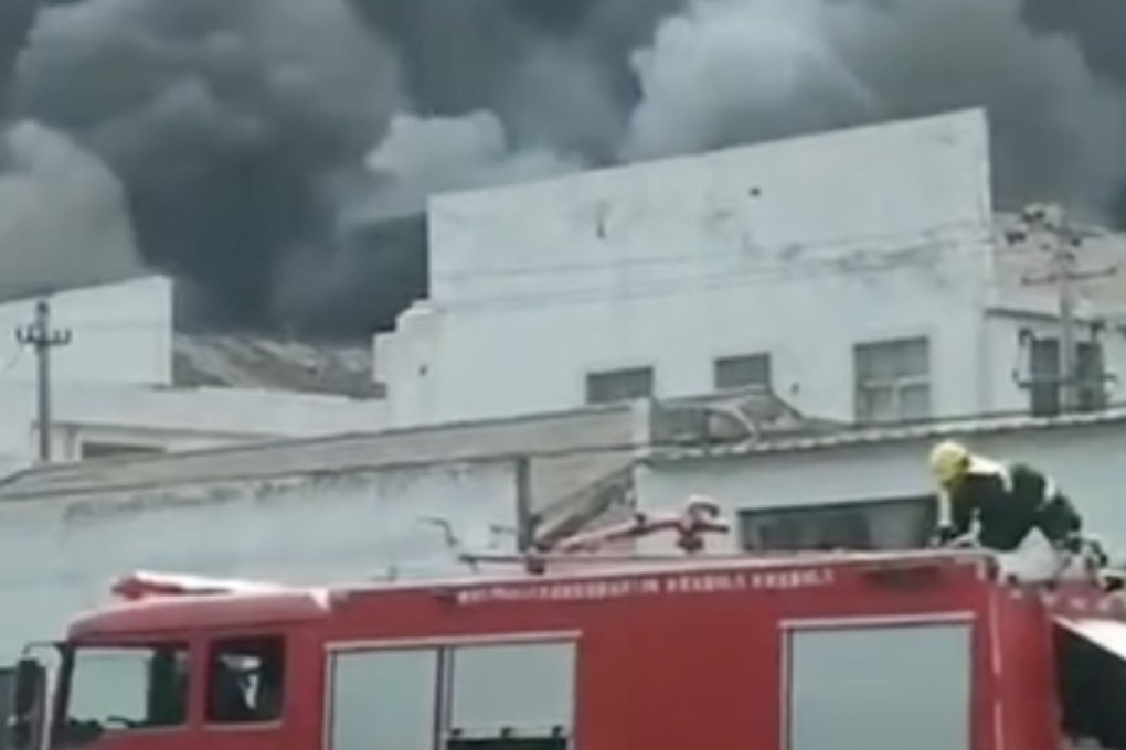 Firefighters tackle the blaze in Ninghai county on Sunday. Photo: Weibo