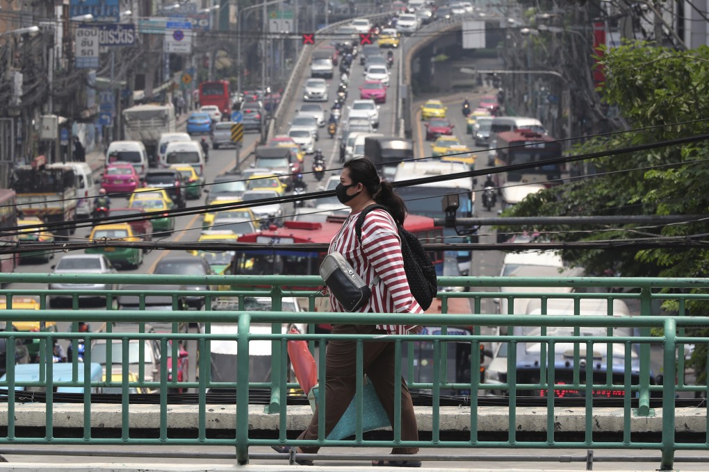 A pedestrian wears a face mask to filter dirty air in Bangkok on Monday. Photo: AP