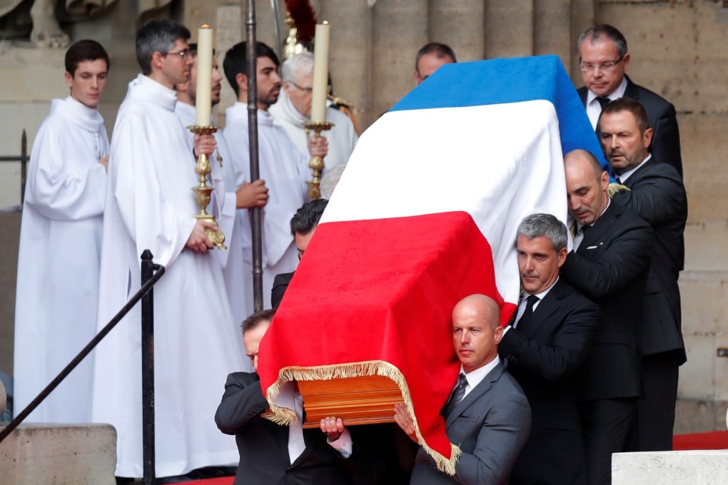 Pallbearers carry the flag-draped coffin of late French President Jacques Chirac after the funeral. Photo: Reuters
