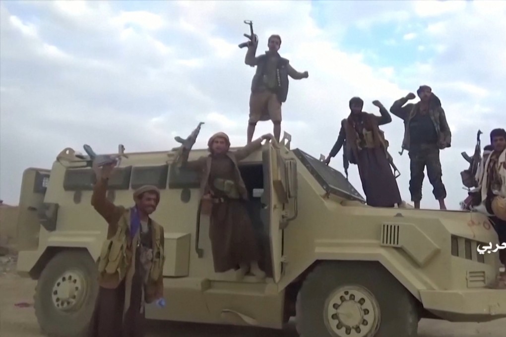 Houthi fighters pose on an alleged captured Saudi vehicle. Photo: Handout via Reuters