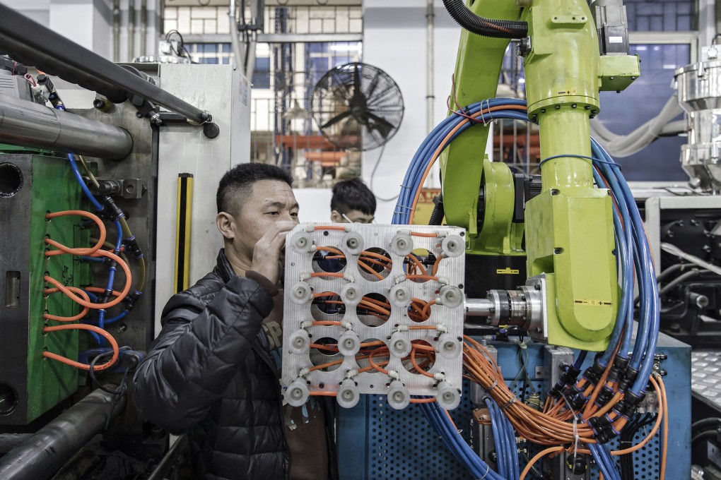 A technician adjusts an industrial robot manufactured by E-Deodar Robot Equipment as it stands on the production line of Guangdong Shiyi Furniture in Foshan, China, on Feb. 28, 2017. Photo: Bloomberg