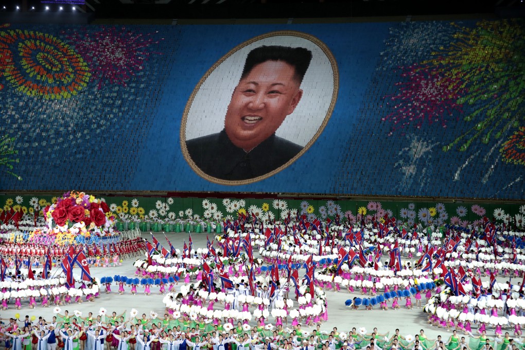 Performers hold up cards to form a portrait of North Korean leader Kim Jong-un during a mass games performance. Photo: AP