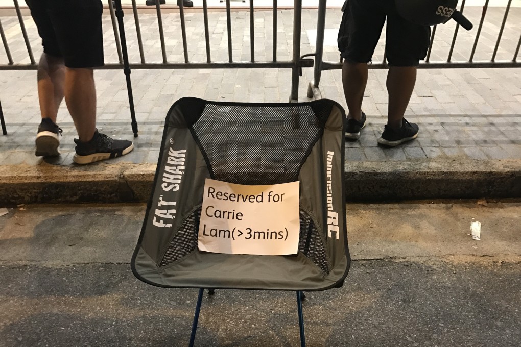 As Chief Executive Carrie Lam and her key officials conduct a dialogue session at Queen Elizabeth Stadium in Wan Chai on September 26, protesters outside place a chair for her, daring the leader to come out and talk to them. Photo: Yujing Liu