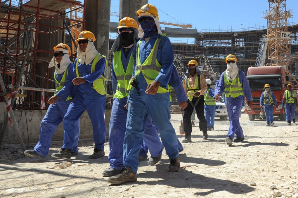 Foreign labourers leave a construction site in Qatar. Photo: EPA