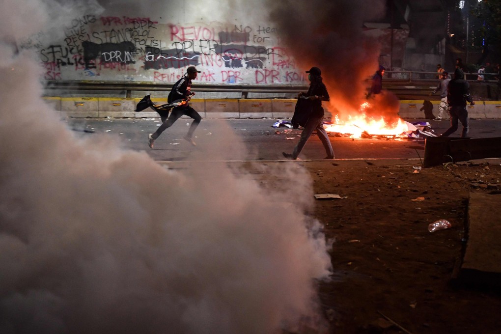 Indonesian students set items on fire as police shoot tear gas in Jakarta on Monday. Photo: AFP