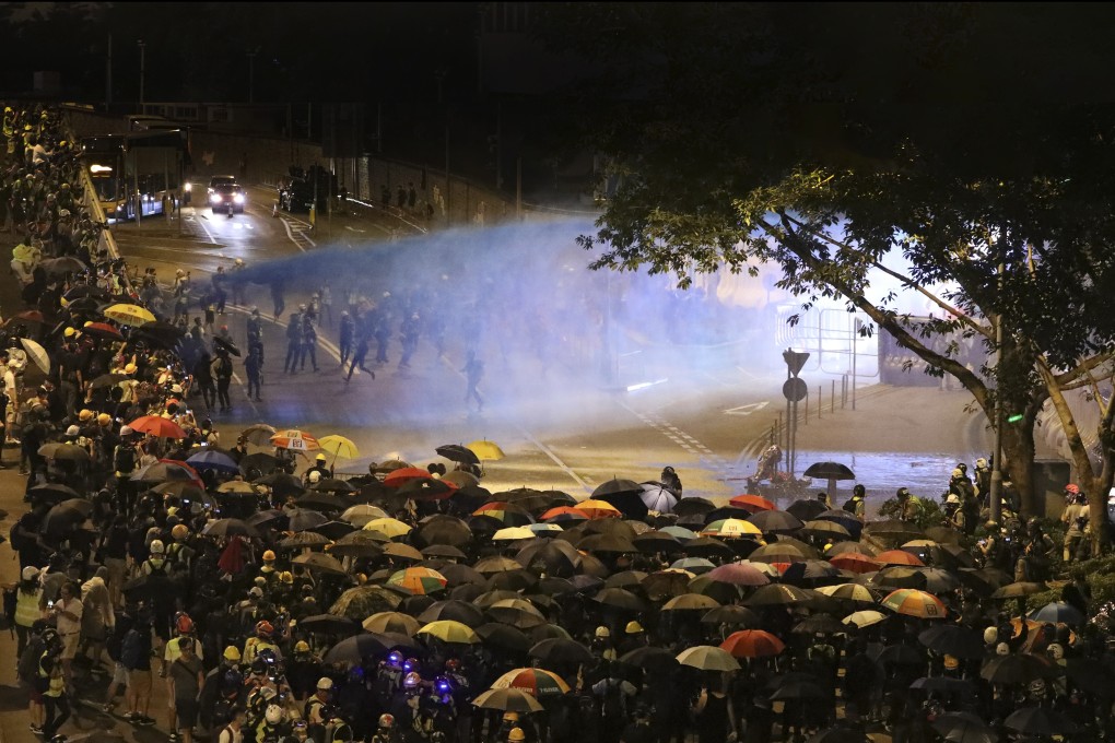 Riot police use water cannons to disperse a crowd of anti-government protesters gathered near the Legislative Council Complex in Admiralty, after a rally to mark the fifth anniversary of the “Umbrella movement” on September 28. Photo: Dickson Lee