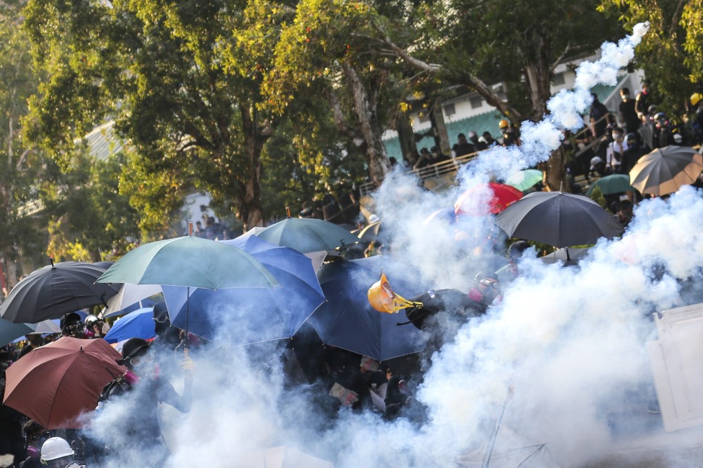 Riot police fire tear gas in Wong Tai Sin following scuffles during a mass rally on the 70th anniversary of the founding of the People’s Republic of China: Photo: James Wendlinger