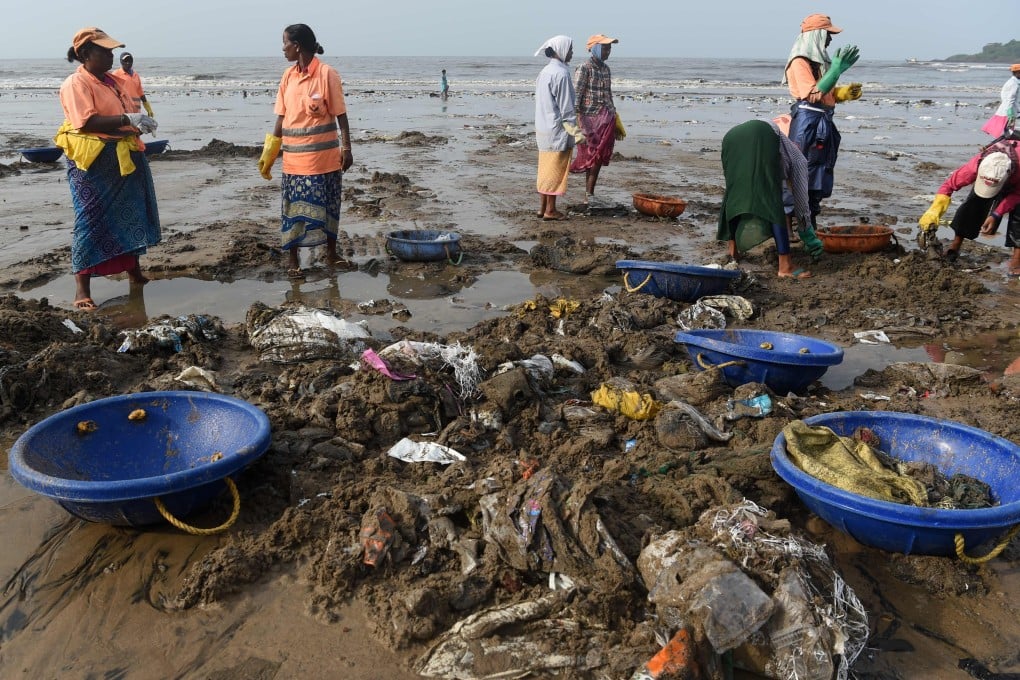 Indian workers pick up plastic waste and trash during a clean-up drive on Versova beach in Mumbai. Photo: AFP