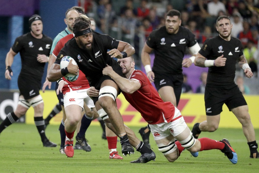 New Zealand's Patrick Tuipulotu is tackled by a Canadian defender during their game in Oita, Japan. Photo: AP