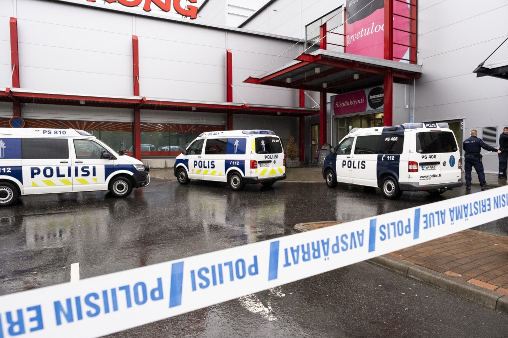 Police vehicles and officers outside the shopping centre where a fatal sword attack took place. Photo: dpa