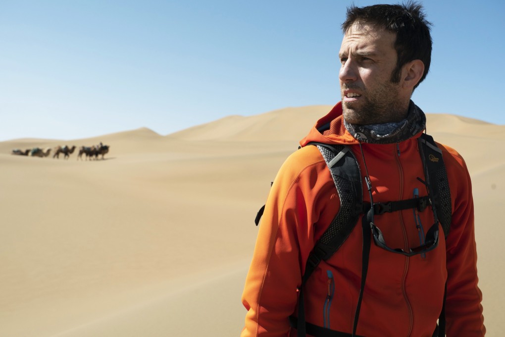 Ryan Pyle trekking through the Badain Jaran desert, in northern China, while filming for Discovery Channel. Photo: Ryan Pyle