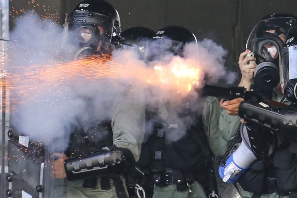 Riot police fire tear gas in Wong Tai Sin amid mass protests on National Day. Photo: James Wendlinger