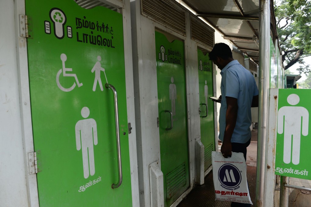 A man waits to use a public toilet on a street in India’s Chennai. Photo: AFP
