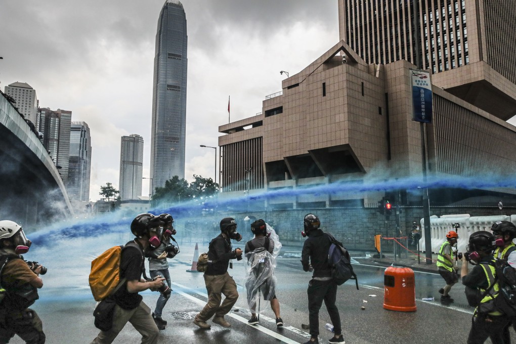 A police water cannon is used on protesters in Admiralty on August 31, against the backdrop of iconic buildings in Hong Kong’s central business district. Photo: Sam Tsang