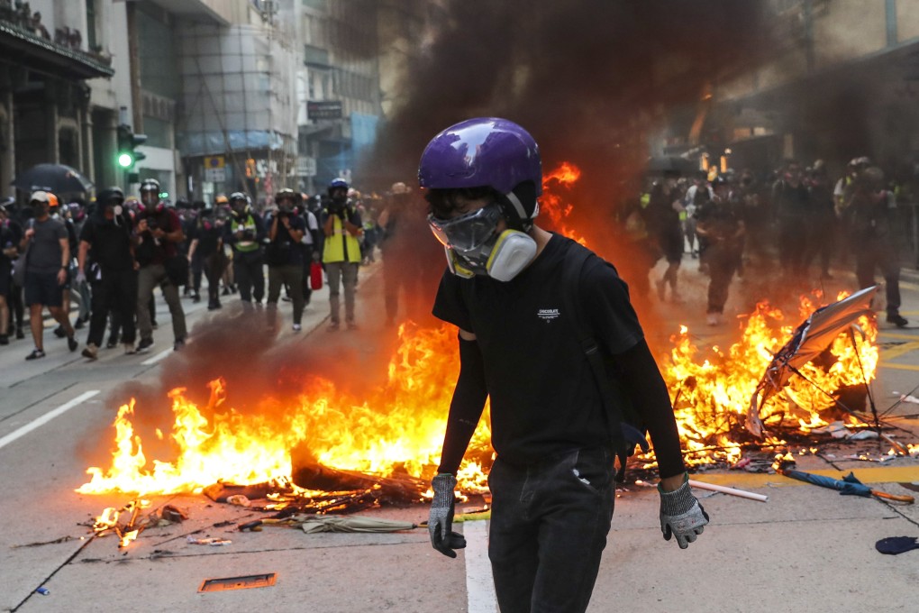 A fire burns on a road in Hong Kong on October 1. The violent protests are harming everyone, but perhaps worst of all for the long term, Hong Kong’s reputation as a safe and civilised place to do international business is suffering. Photo: Sam Tsang