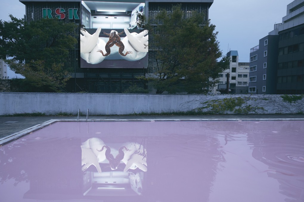 Irish artist John Gerrard's projection X. laevis (Spacelab) is reflected in Skin Pool (Oromom) by Swiss artist Pamela Rosenkranz, a swimming pool filled with a bubbling pink liquid, at The Okayama Art Summit in Setouchi, western Japan. Photo: Ola Rindal/The Okayama Art Summit 2019