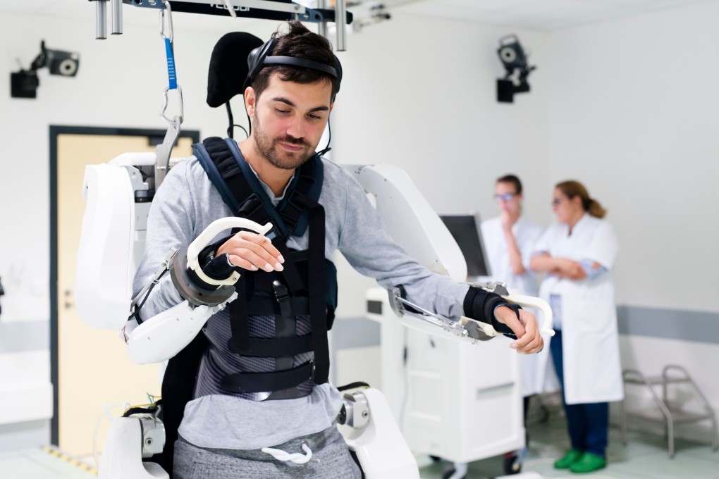 French quadriplegic Thibault stands while wearing an exoskeleton at Clinatec laboratory at the University of Grenoble. Photo: AFP