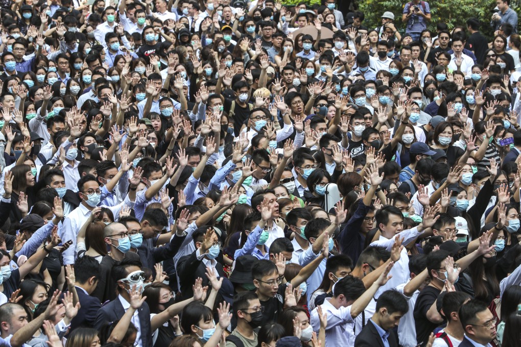 Masked protesters hold a flash mob rally at Chater Garden on Tuesday. Photo: Sam Tsang