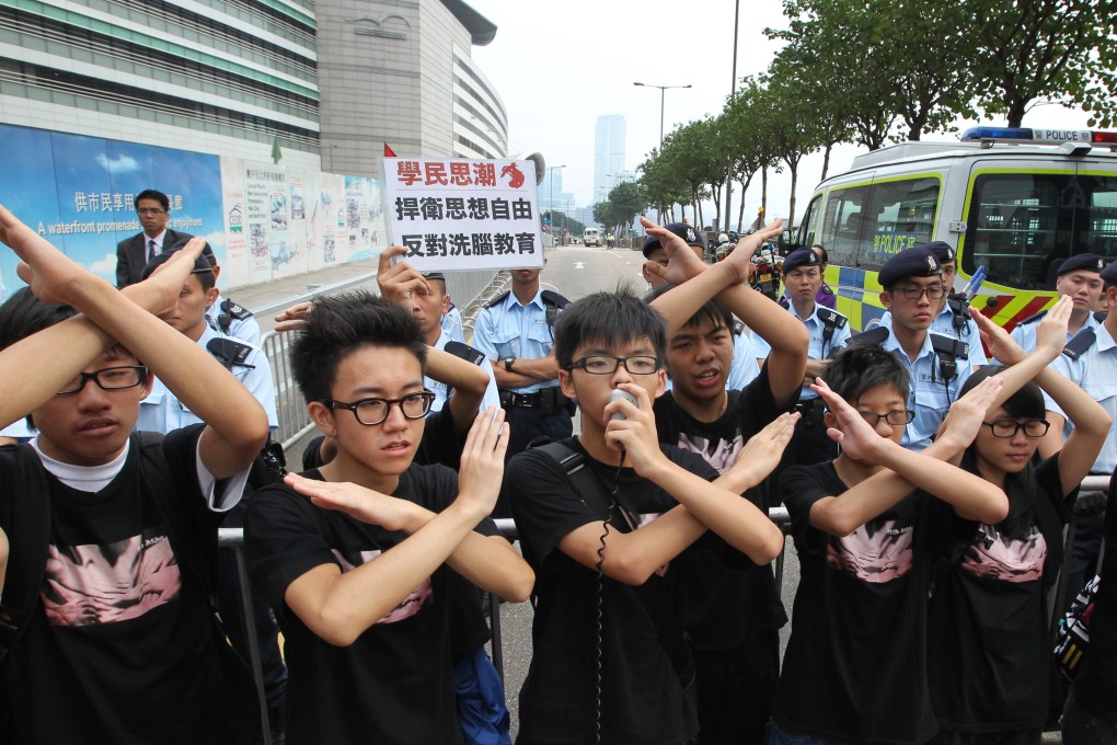 Members of student group Scholarism, including its convenor Joshua Wong Chi-fung, protest at Golden Bauhinia Square. Photo: Nora Tam