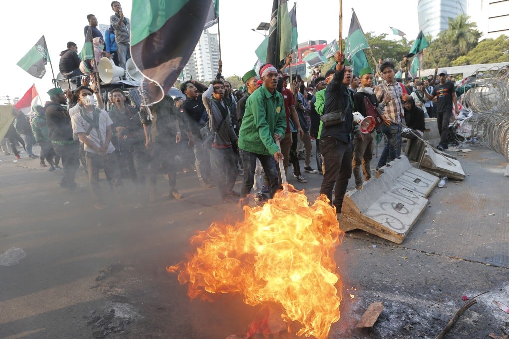 Student protesters burn tyres during a protest against proposed legislation which would punish sex outside marriage, infringe on gay rights, limit free speech and weaken the country’s anti-corruption agency. Photo: AP