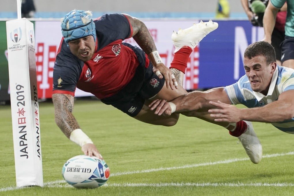 England’s Jack Nowell of England scores a try past Emiliano Boffelli of Argentina during their Rugby World Cup match. Photo: EPA