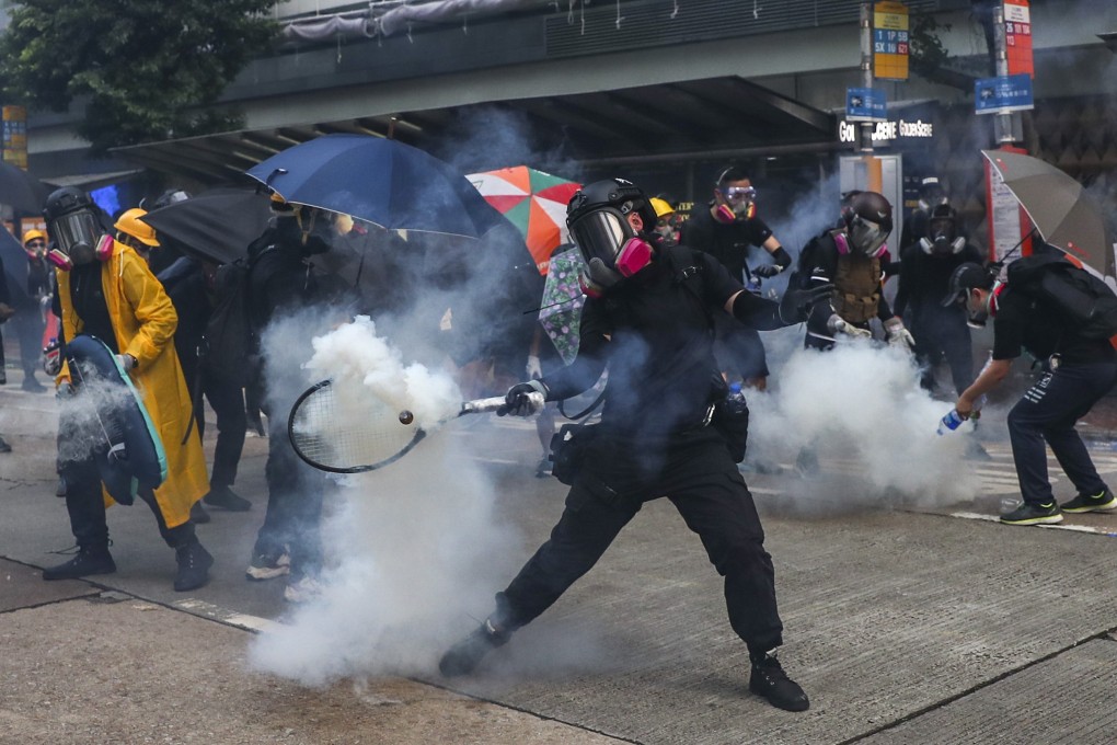 Masked protesters react to tear gas in Hong Kong on Sept. 29. Photo: Sam Tsang
