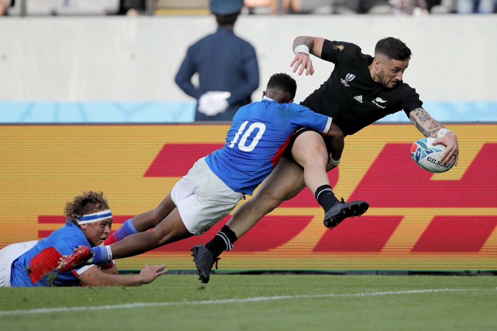 New Zealand’s T J Perenara looks to score a try as he is tackled by Namibia’s Helarius Kisting during the Rugby World Cup pool B game at Tokyo Stadium. Photo: AP