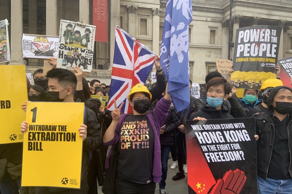 Some of the hundreds of masked pro-democracy Hong Kong students and supporters at a rally in London on Saturday. Photo: Hilary Clarke