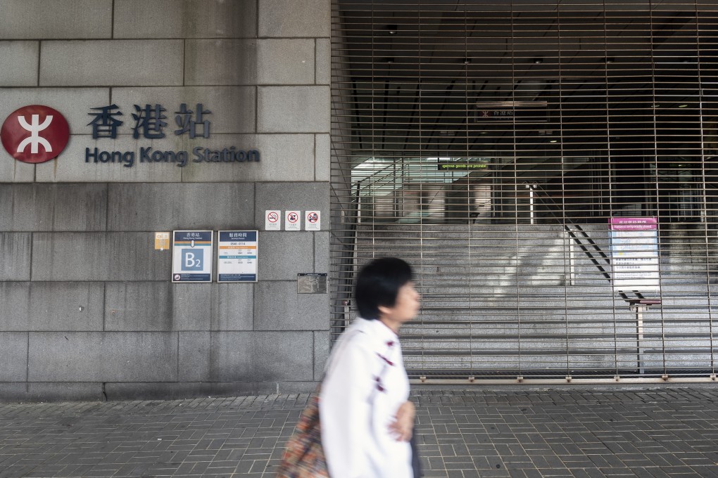 A pedestrian walks past a closed entrance to Hong Kong Station, operated by MTR Corp., the morning after the government announced the newly imposed ban on masks in the Central district of Hong Kong, China, on Saturday Photo: Bloomberg
