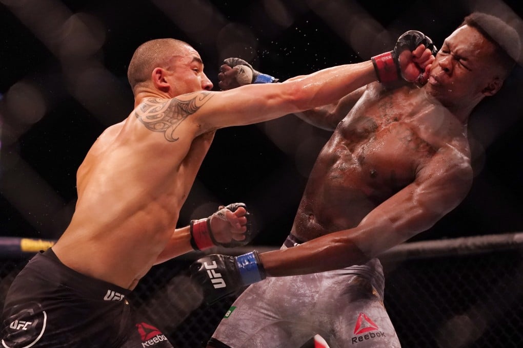 Robert Whittaker hits Israel Adesanya at UFC 243. Photo: EPA
