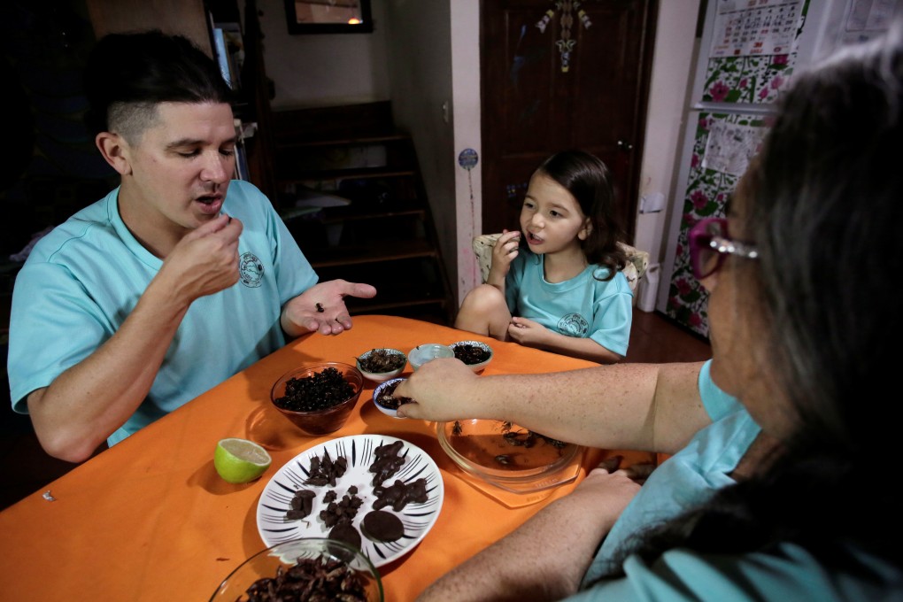 Biologist Federico Paniagua and family eat insects at their farm in Grecia, Costa Rica. Three years ago, he replaced the animal protein in their meals with ants, crickets, cockroaches, beetles and the like, all of which he farms in the Central American country. Photo: Reuters/Juan Carlos Ulate