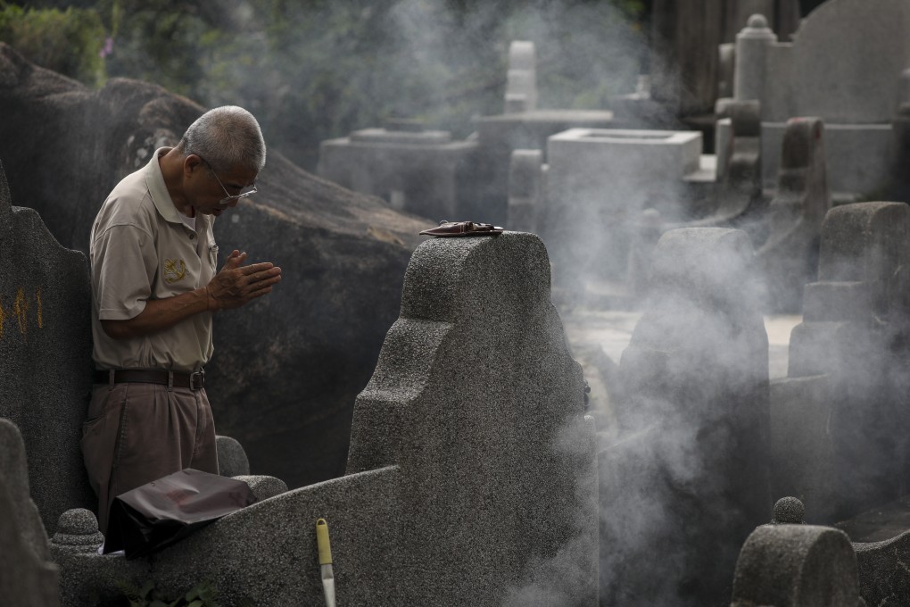 A visitor at the Diamond Hill cemetery pays his respects to his ancestors. Photo: Nora Tam