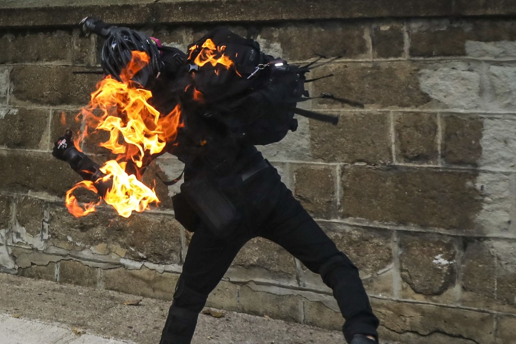 A protester accidentally sets himself on fire while throwing a petrol bomb in Yau Ma Tei on October 01. Photo: Dickson Lee