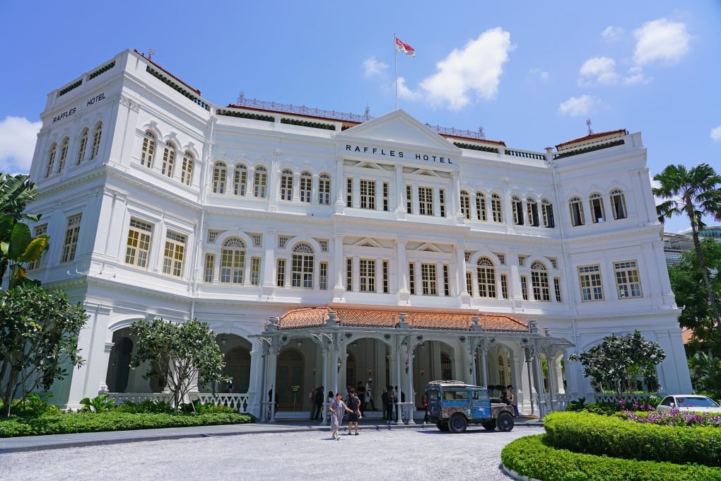 The famous gleaming white frontage and tall arched windows of The Raffles hotel in Singapore’s Civic District. Photo: Alamy