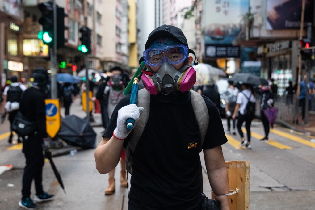 A protester wears a gas mask in defiance of the city’s anti-mask law on October 6. Photo: Bloomberg