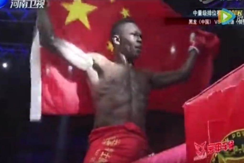 Israel Adesanya holds up the Chinese flag. Photo: YouTube