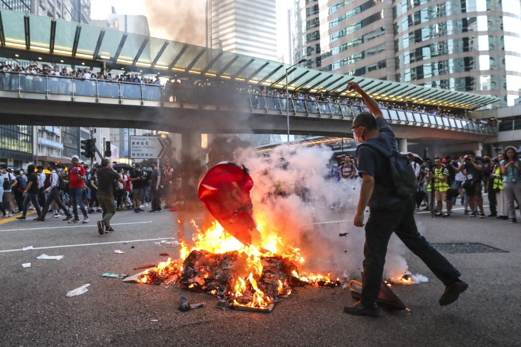 Protesters rally in Central and set objects on fire against the new anti-mask law introduced by the government on Friday. Photo: Felix Wong
