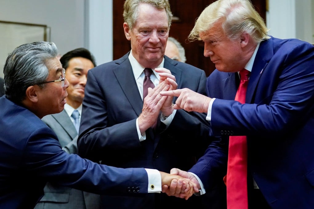US President Donald Trump shakes hands with Japan’s ambassador to the US Shinsuke Sugiyama in front of US Trade Representative Robert Lighthizer. Photo: Reuters