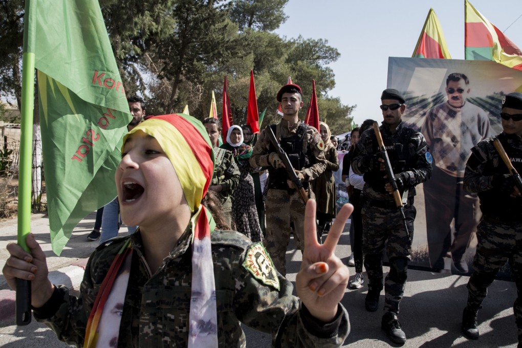 Fighters of the Syrian Democratic Forces march during a demonstration against possible Turkish military operations. Photo: AP