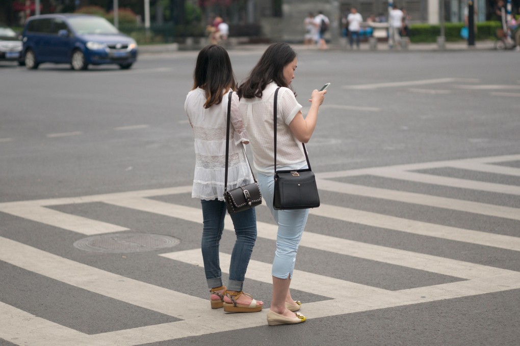 A city in eastern Zhejiang province is banning the use of phones while crossing the road. Photo: Alamy