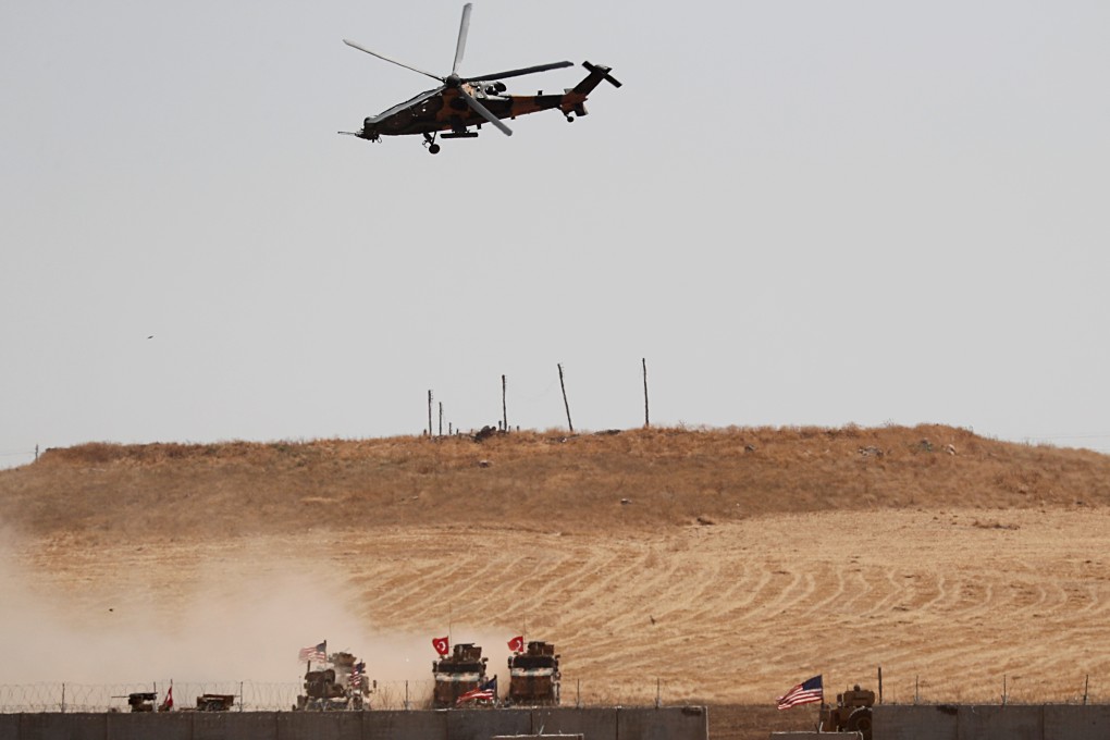 A Turkish military helicopter flies over as Turkish and US troops return from a joint US-Turkey patrol in northern Syria in September. Photo: Reuters