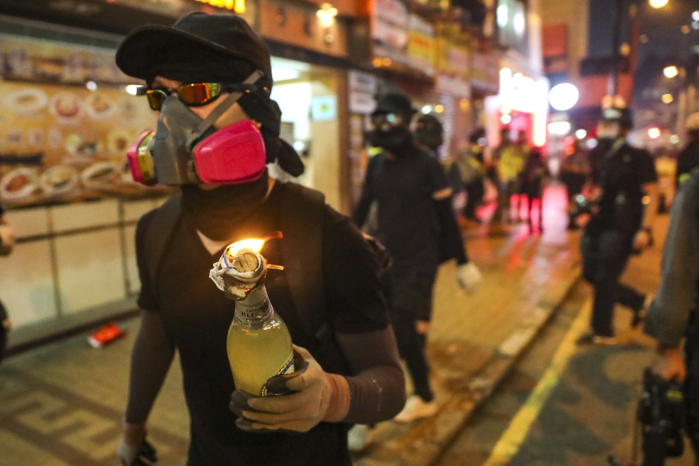 An anti-government protester carrying a petrol bomb walks through the streets of Hong Kong during a clash with police. Photo: Sam Tsang